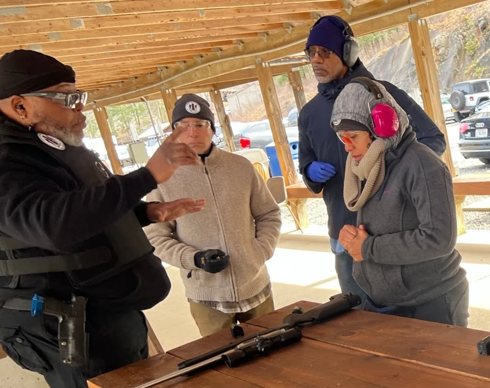 Students listening to Damon Wright during an outdoor range lesson